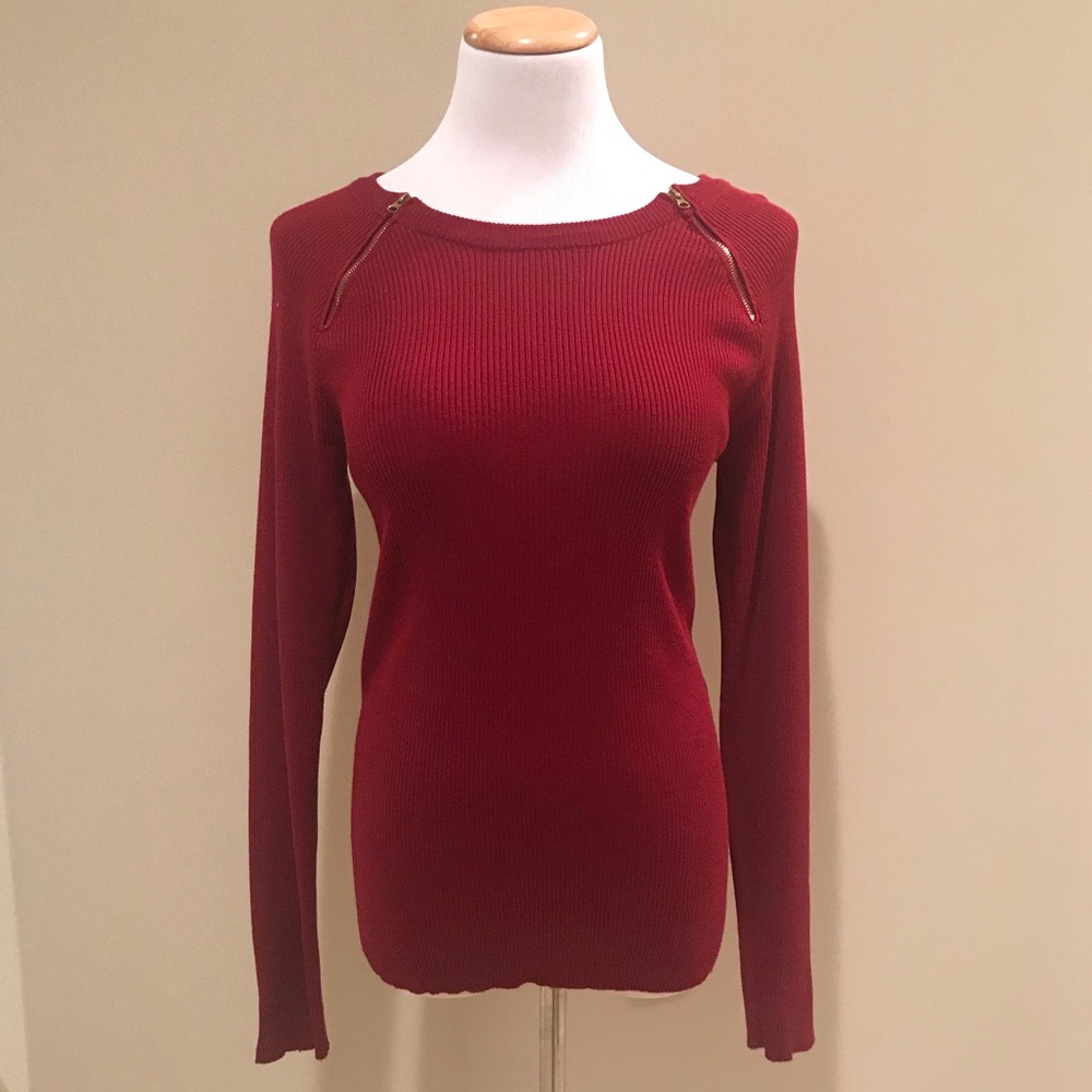 red sweater with golden zippers